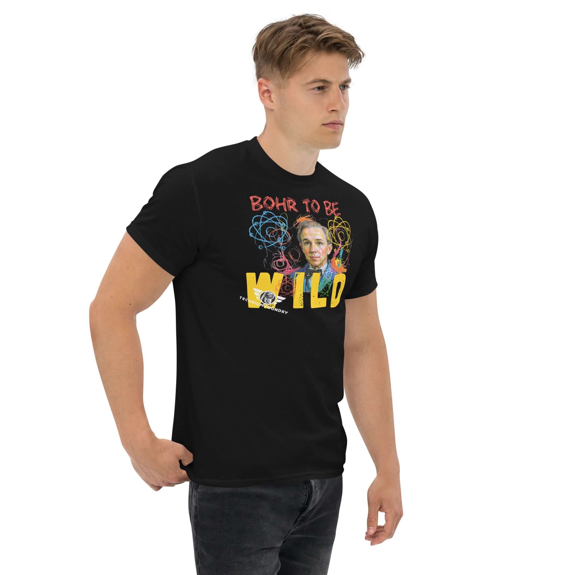 Man wearing 'Bohr to Be Wild' T-shirt featuring artistic Niels Bohr portrait and colorful atomic design.