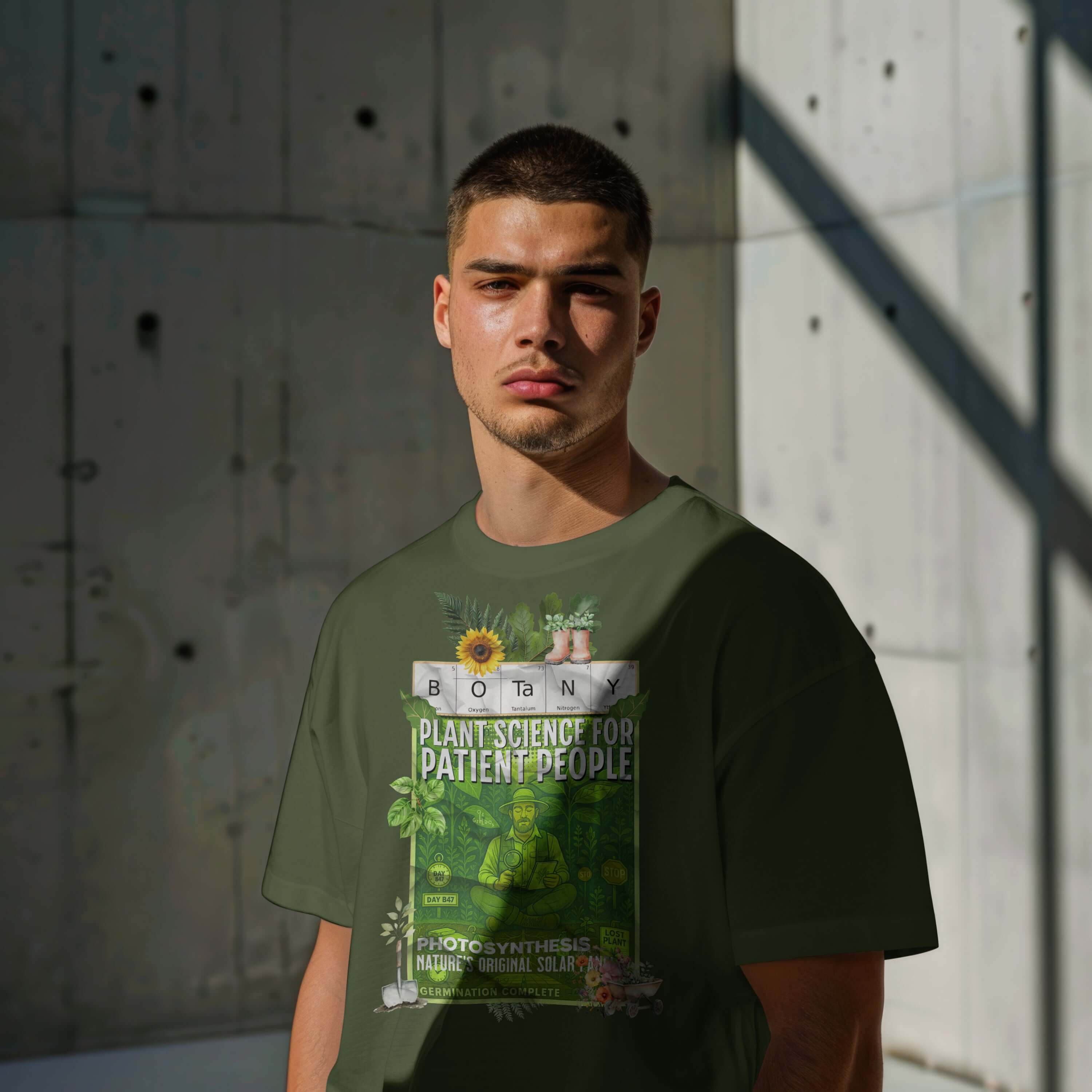 Alt Tag: Man modeling green Botany T-Shirt with 'Plant Science For Patient People' design in urban setting, embracing nature's serenity.