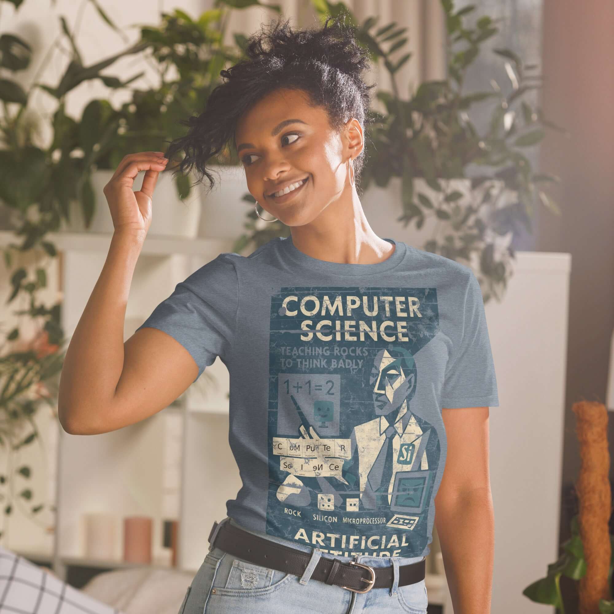Woman wearing a 'Computer Science: Teaching Rocks to Think Badly' T-shirt with a vintage educational poster design.