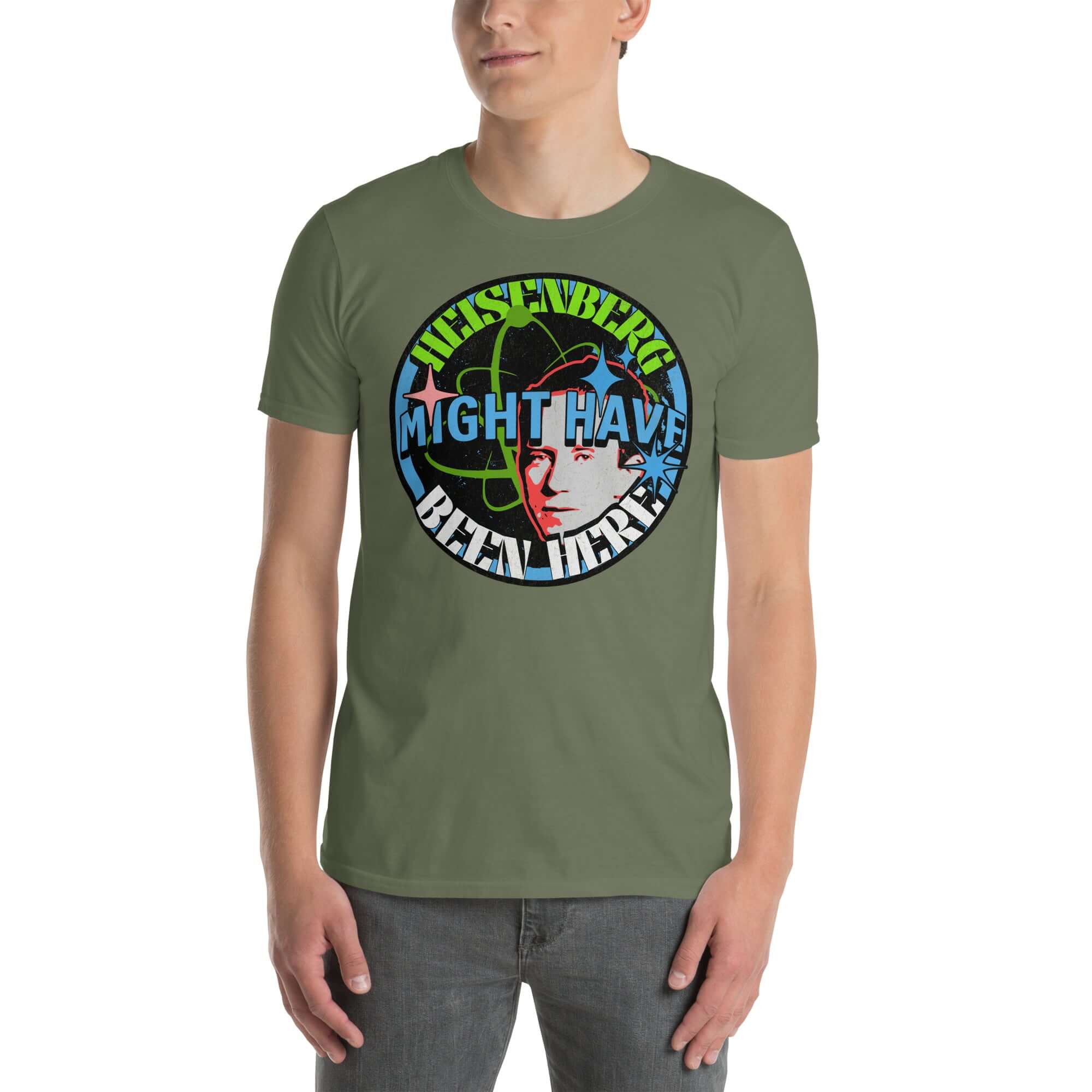 Green t-shirt displaying 'Heisenberg Might Have Been Here' design with atomic symbols and cosmic elements, humorously referencing quantum physics.