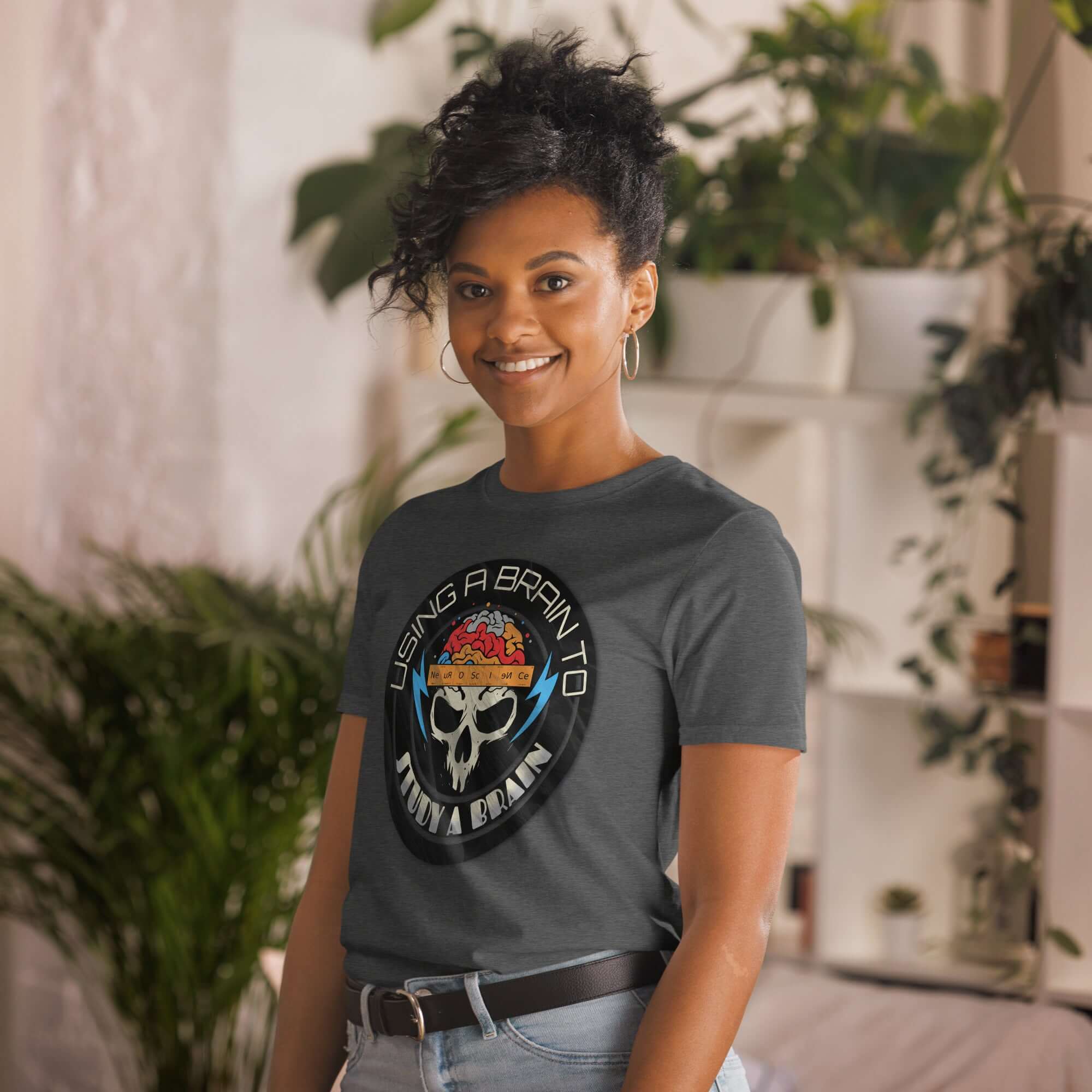 Woman wearing a neuroscience humor T-shirt featuring a brain and skull design with text "Using A Brain To Study A Brain."