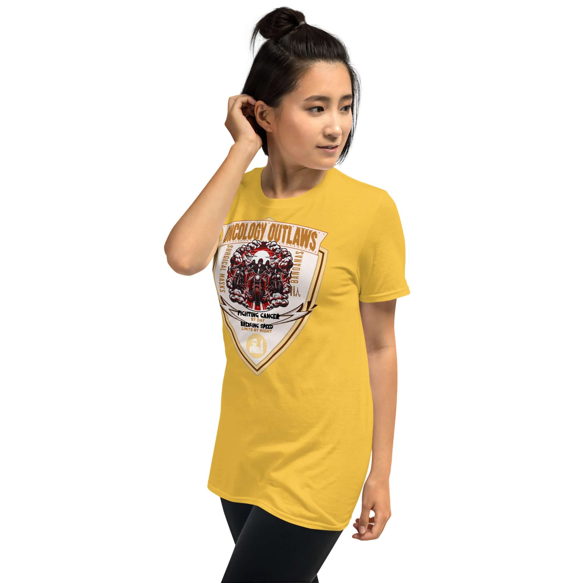 Woman wearing Oncology Outlaws Motorcycle Club T-Shirt, yellow Cancer Fighter Biker Tee with shield-shaped emblem.
