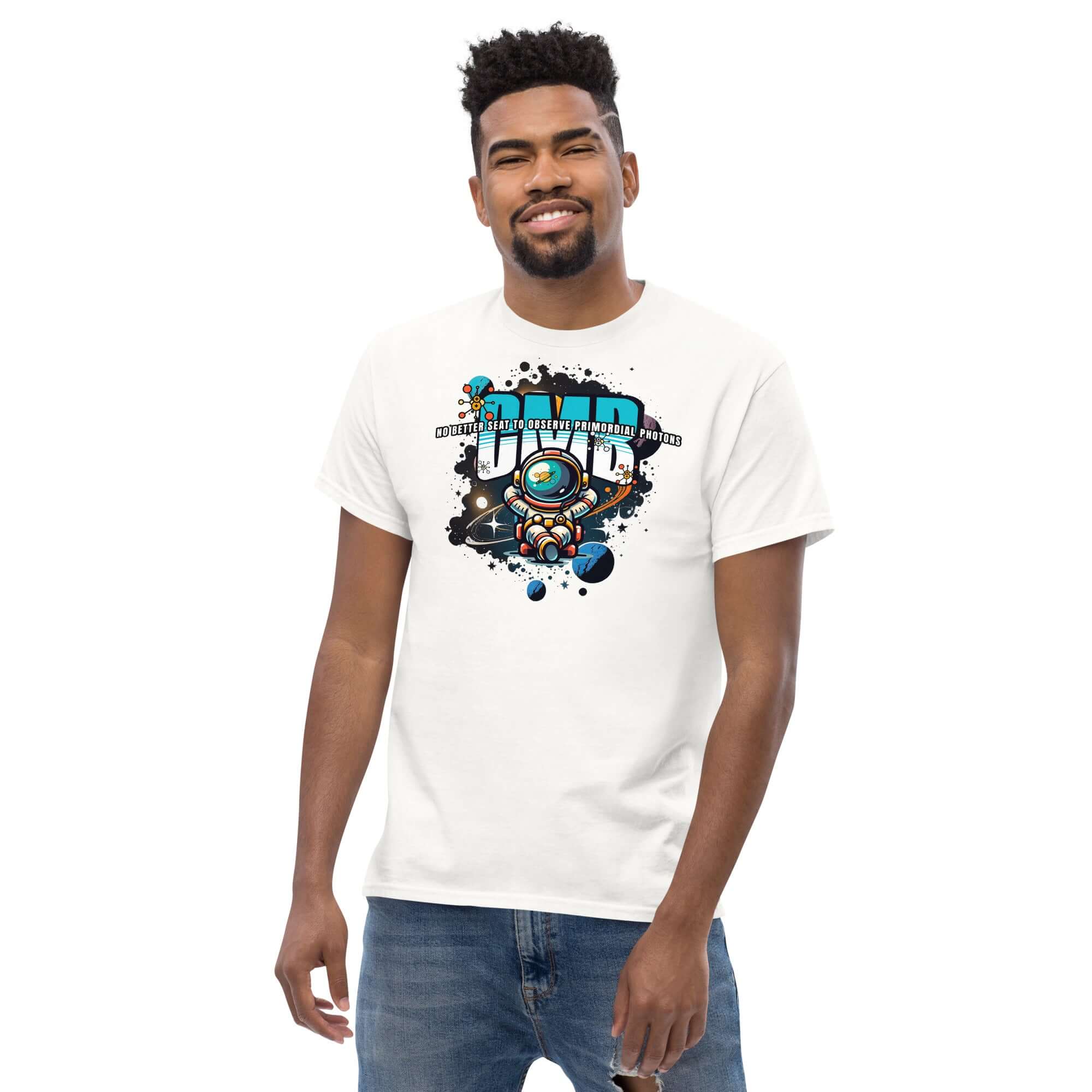 Man wearing 'Primordial Photons' science t-shirt with astronaut and cosmic design, featuring graffiti-style text about observing photons.