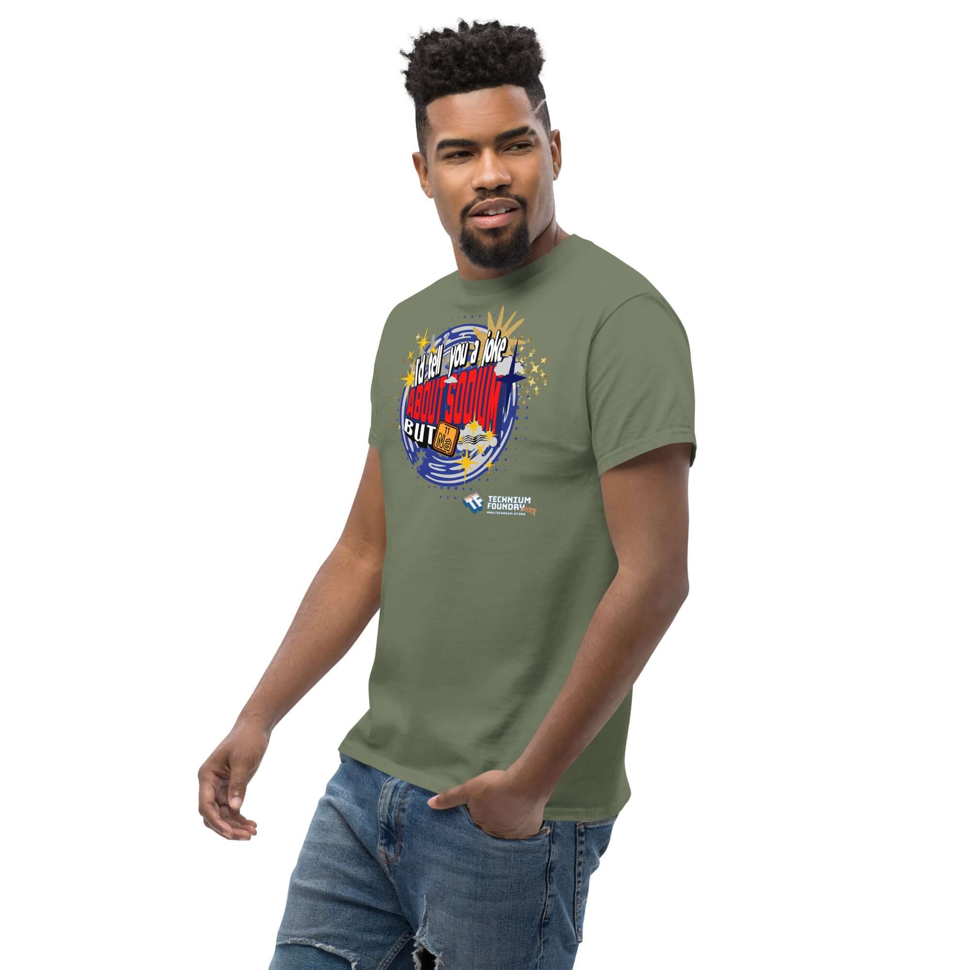 Person wearing a green t-shirt with a "I'd Tell You a Joke About Sodium, But Na" design, featuring a cosmic blue swirl and periodic table pun.
