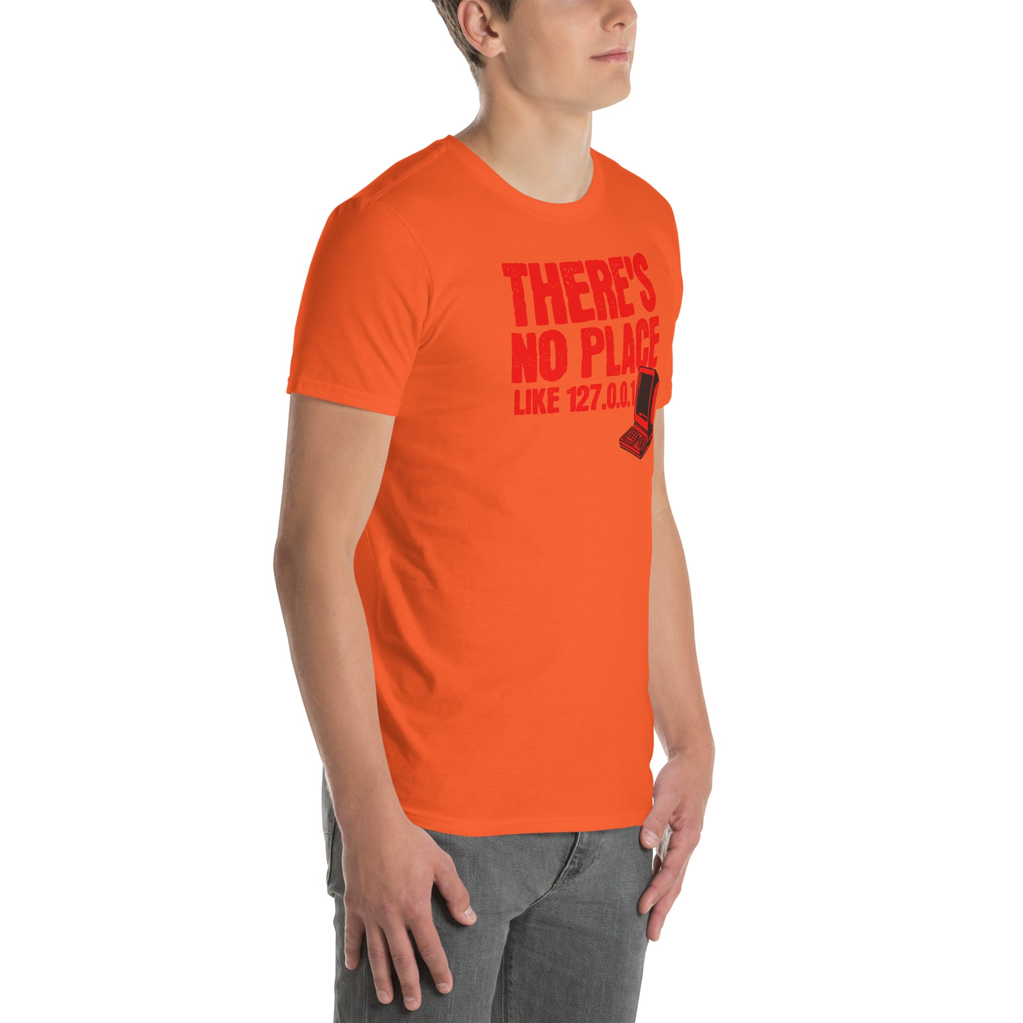 Model wearing "There's No Place Like 127.0.0.1" orange t-shirt, featuring humorous localhost IP address design with bold red text.