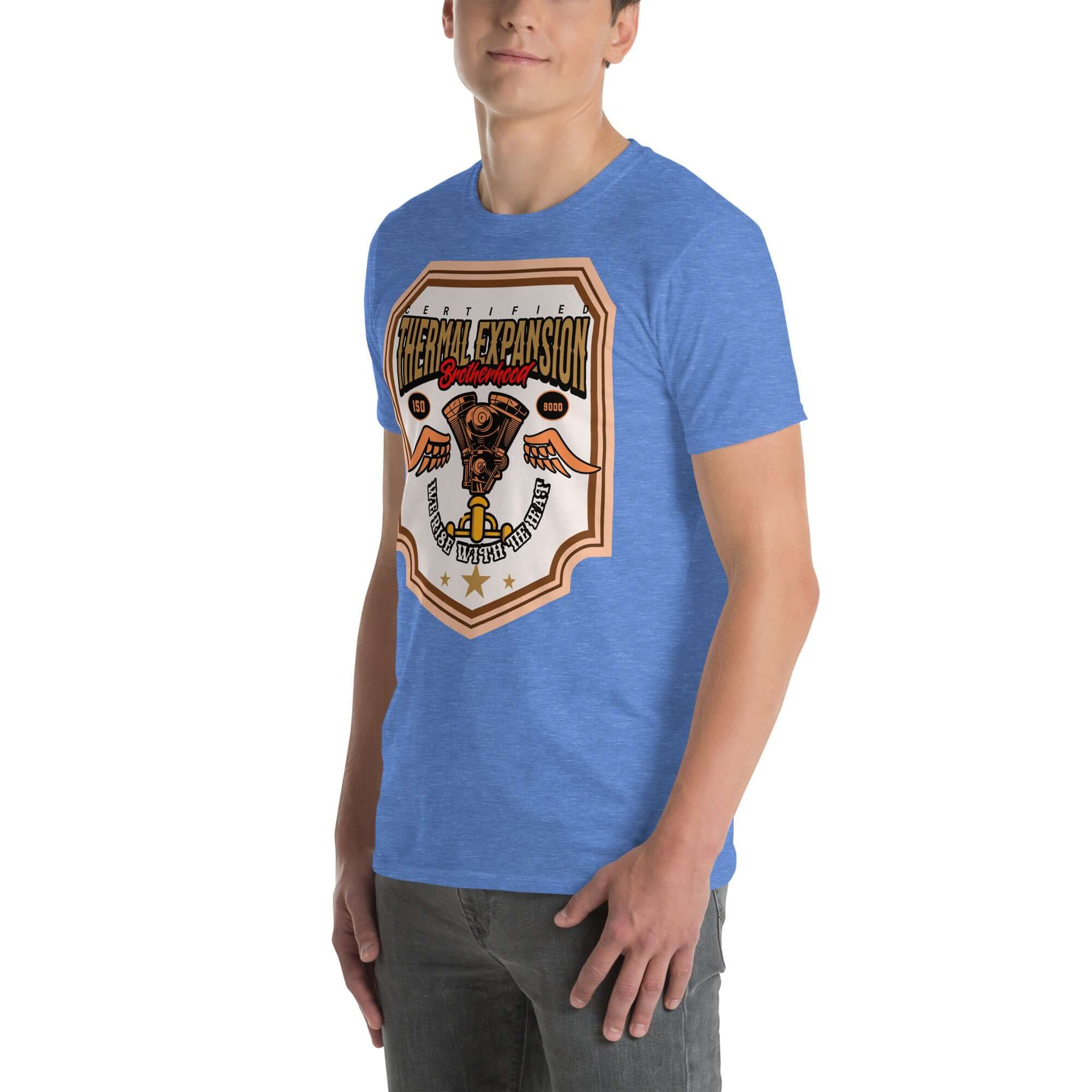 Man wearing a blue Thermal Expansion Brotherhood T-Shirt with V-twin engine and wings design, scientific motorcycle apparel.