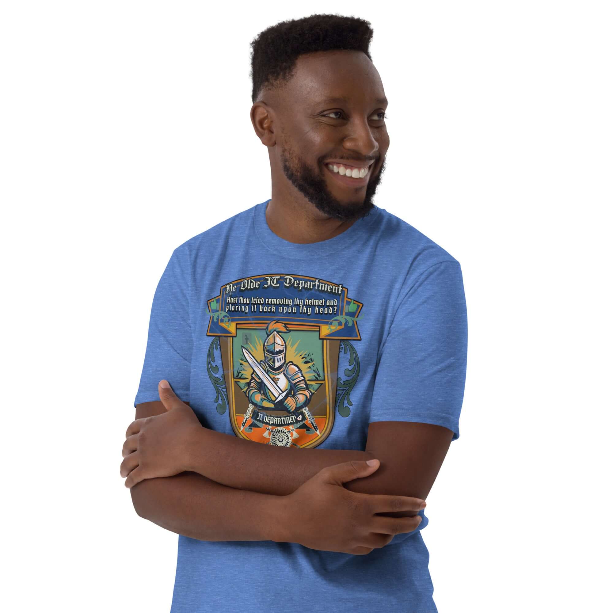 Man wears "Ye Olde IT Department" T-shirt with medieval tech support design, featuring a knight and humorous text, smiling with crossed arms.