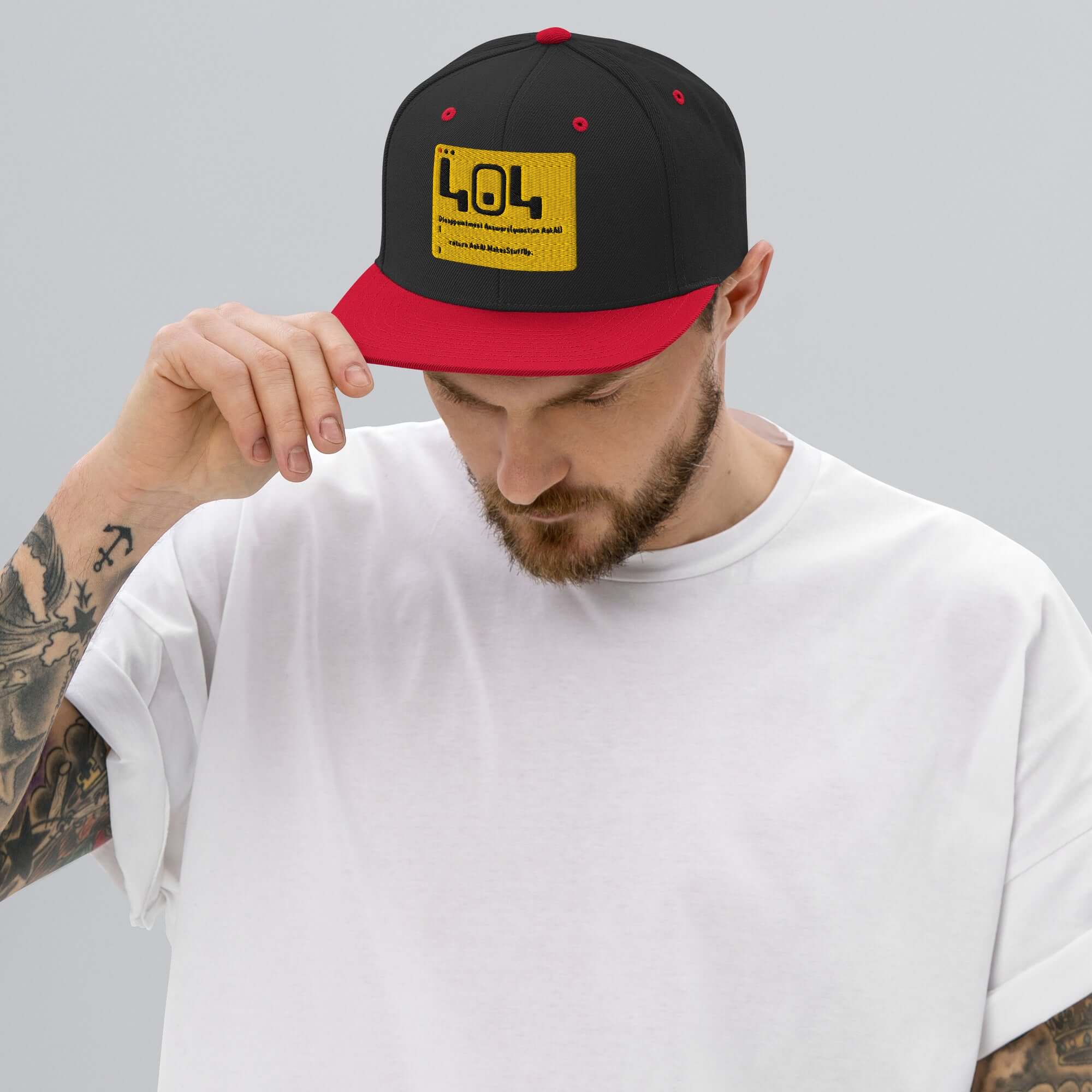 Man wearing 404 Disappointment Hat, black and red snapback, featuring humorous error code for developers.