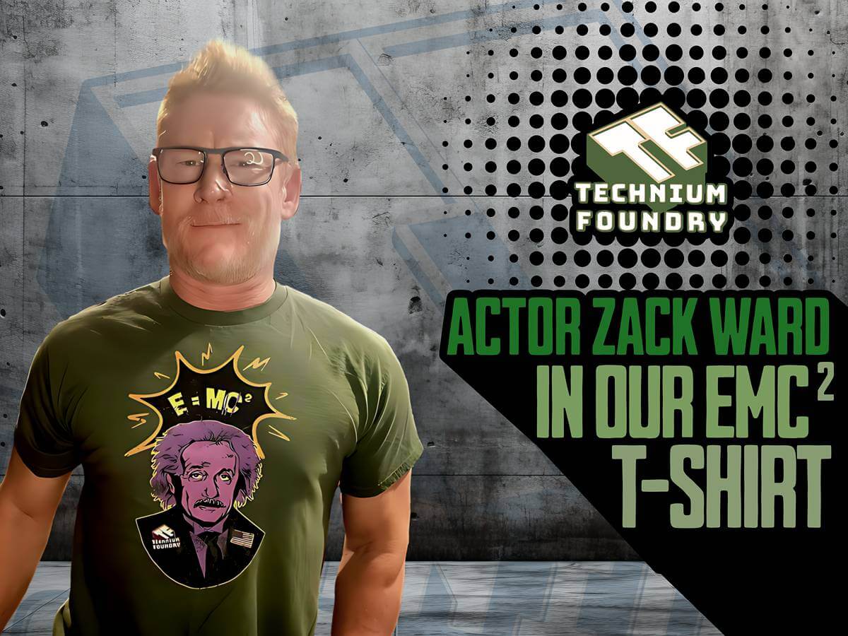 Person wearing Technicum Foundry EMC² T-shirt in front of industrial background.