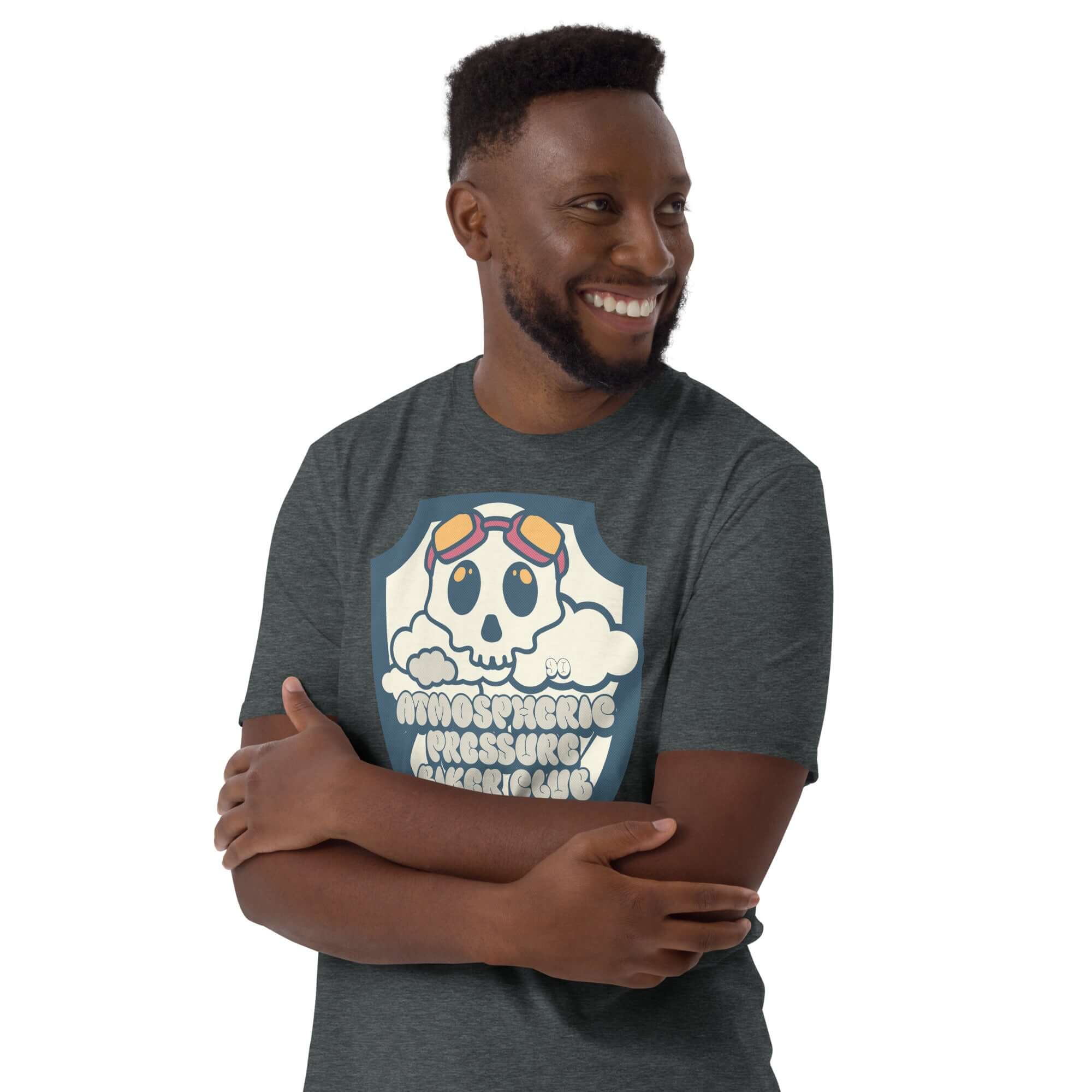 Man wearing Atmospheric Pressure Biker Club T-shirt with cute skull design and aviator goggles among clouds.