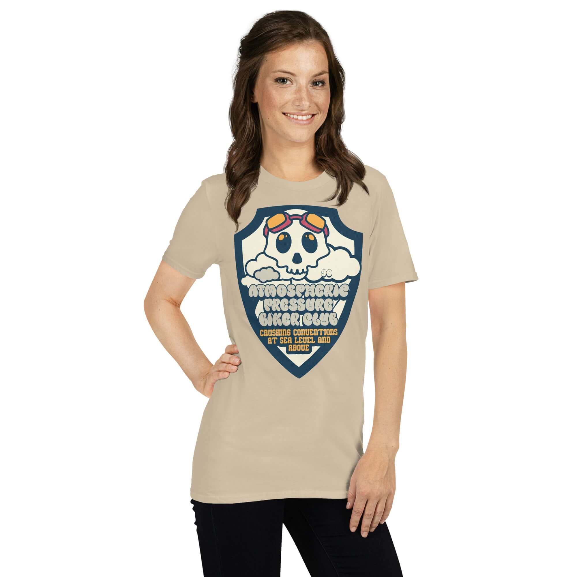Model wearing Atmospheric Pressure Biker Club T-Shirt featuring cute skull design with aviator goggles and clouds.
