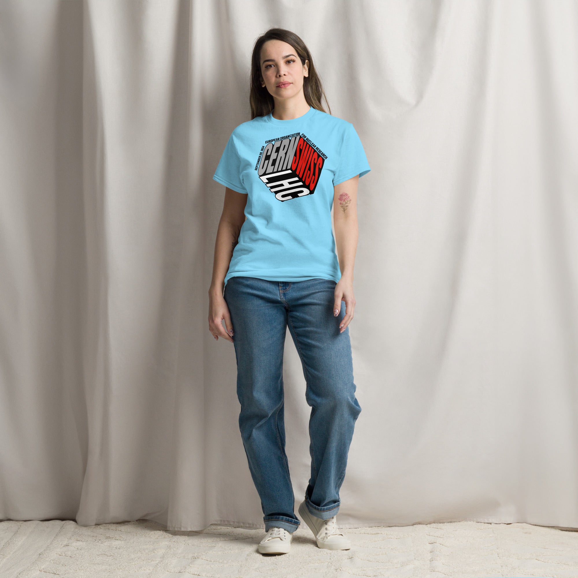 Model wearing CERN/Swiss Physics Cube T-Shirt in olive green with reimagined CERN logo, pairing science with style.