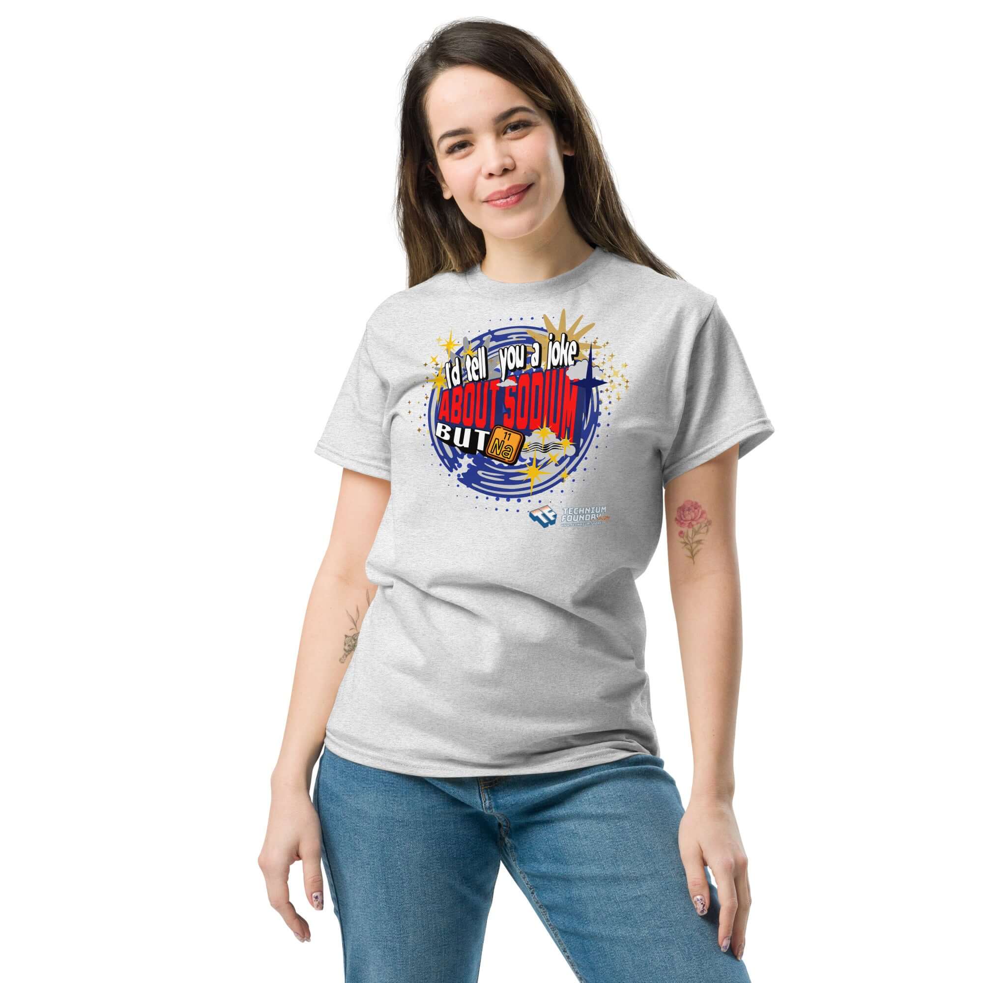 Woman wearing a Sodium Chemistree Joke T-Shirt with cosmic blue swirl design, perfect for chemistry nerds and science pun enthusiasts.