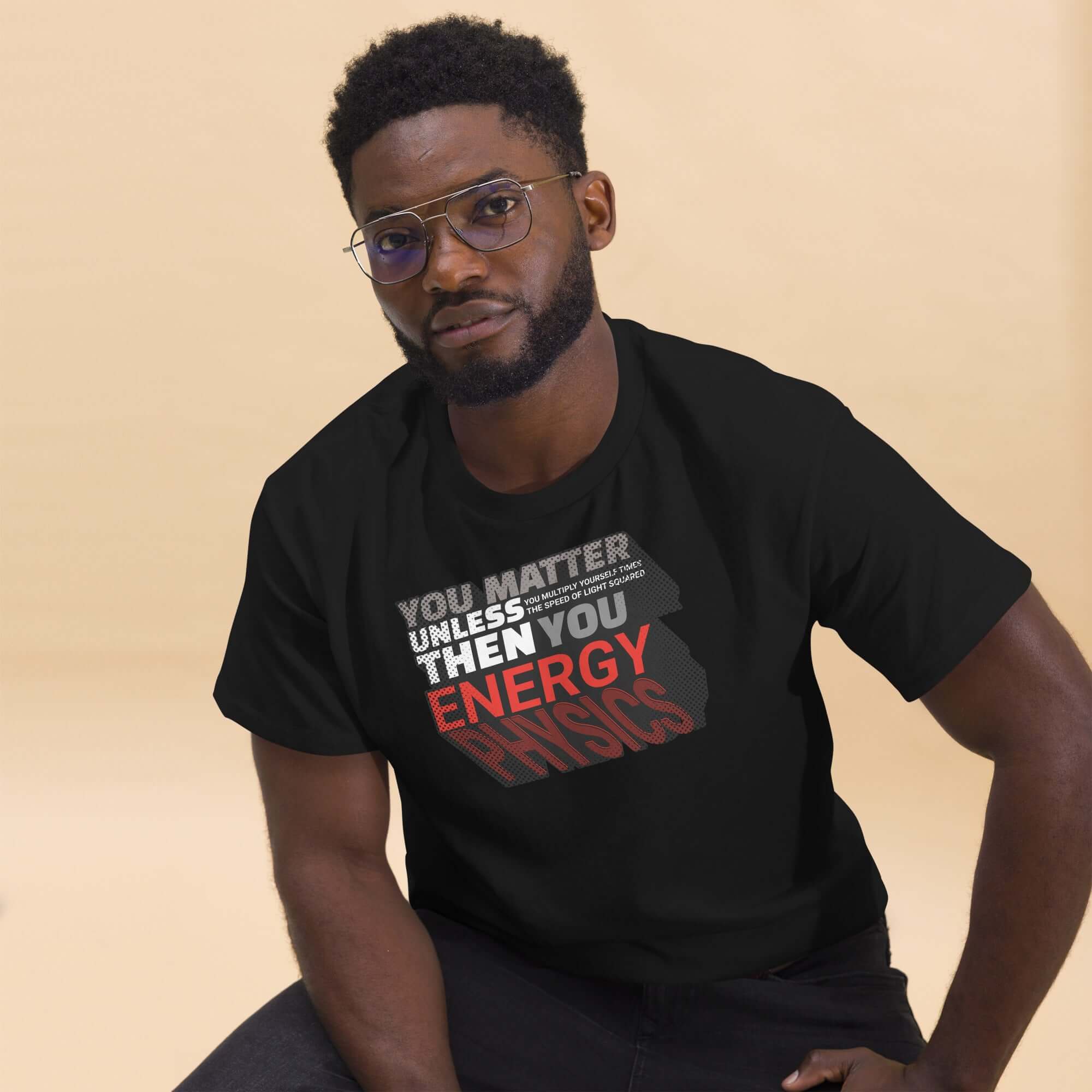 Man wearing Einstein's E=mc² word equation T-shirt with humorous physics quote.