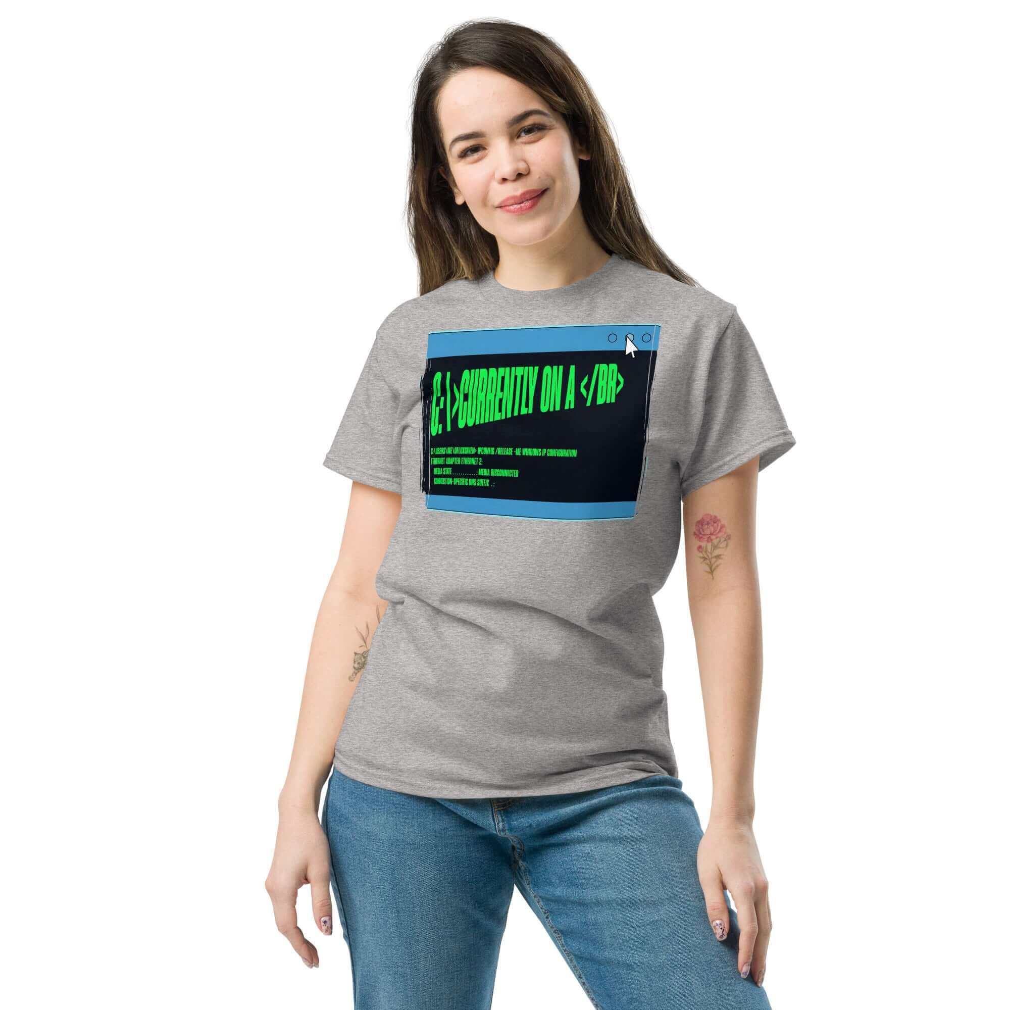 Person wearing a gray t-shirt with digital-themed text design, smiling against a white background.