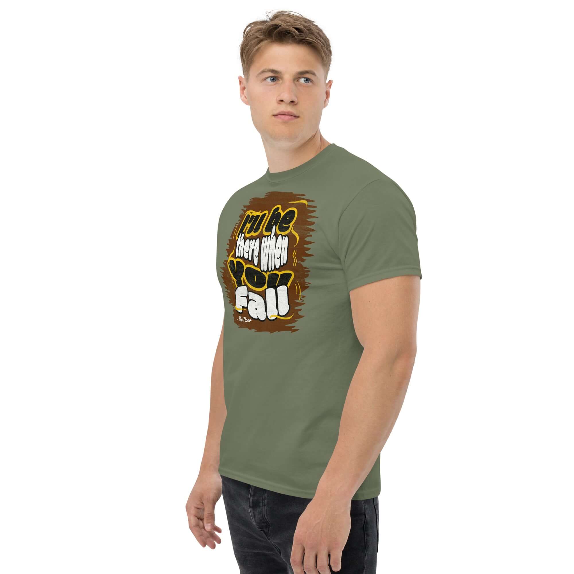 Man wearing "I'll Be There When You Fall" floor quote t-shirt in green, showcasing ironic apparel with a humorous twist.