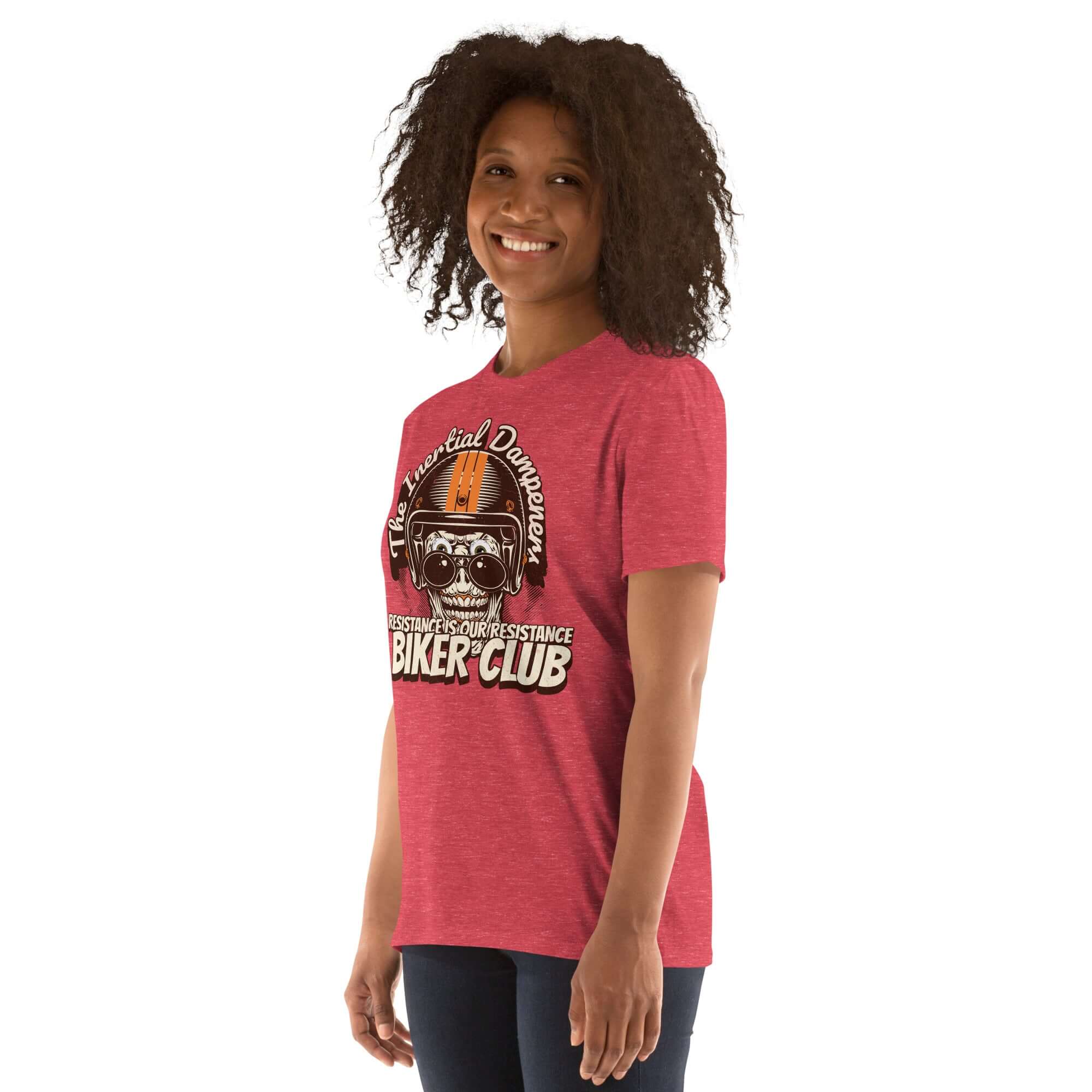 Woman wearing "Inertial Dampeners Biker Club" t-shirt in red with skull and helmet design, blending physics with motorcycle humor.