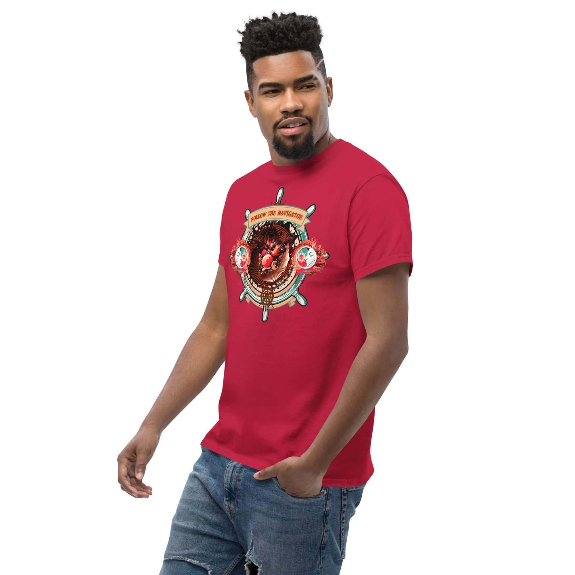 Man wearing a red 'Follow The Navigator' t-shirt featuring a cosmic compass design with nautical and celestial elements.