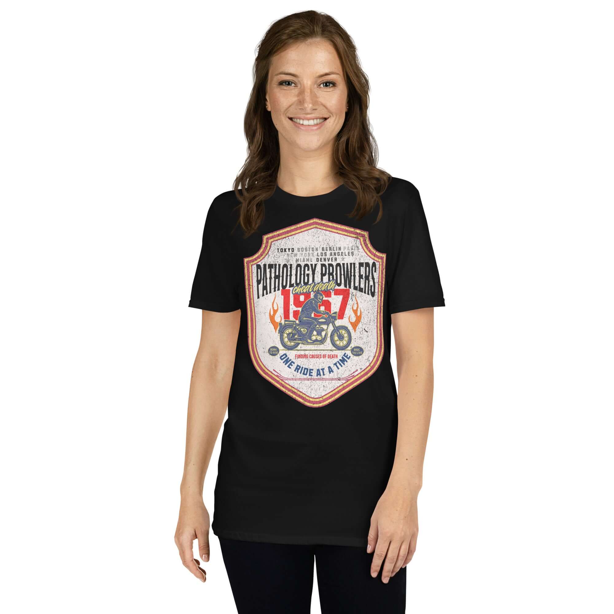 Black Pathology Prowlers MC T-Shirt with vintage shield emblem worn by a woman, celebrating forensic motorcycle club culture.