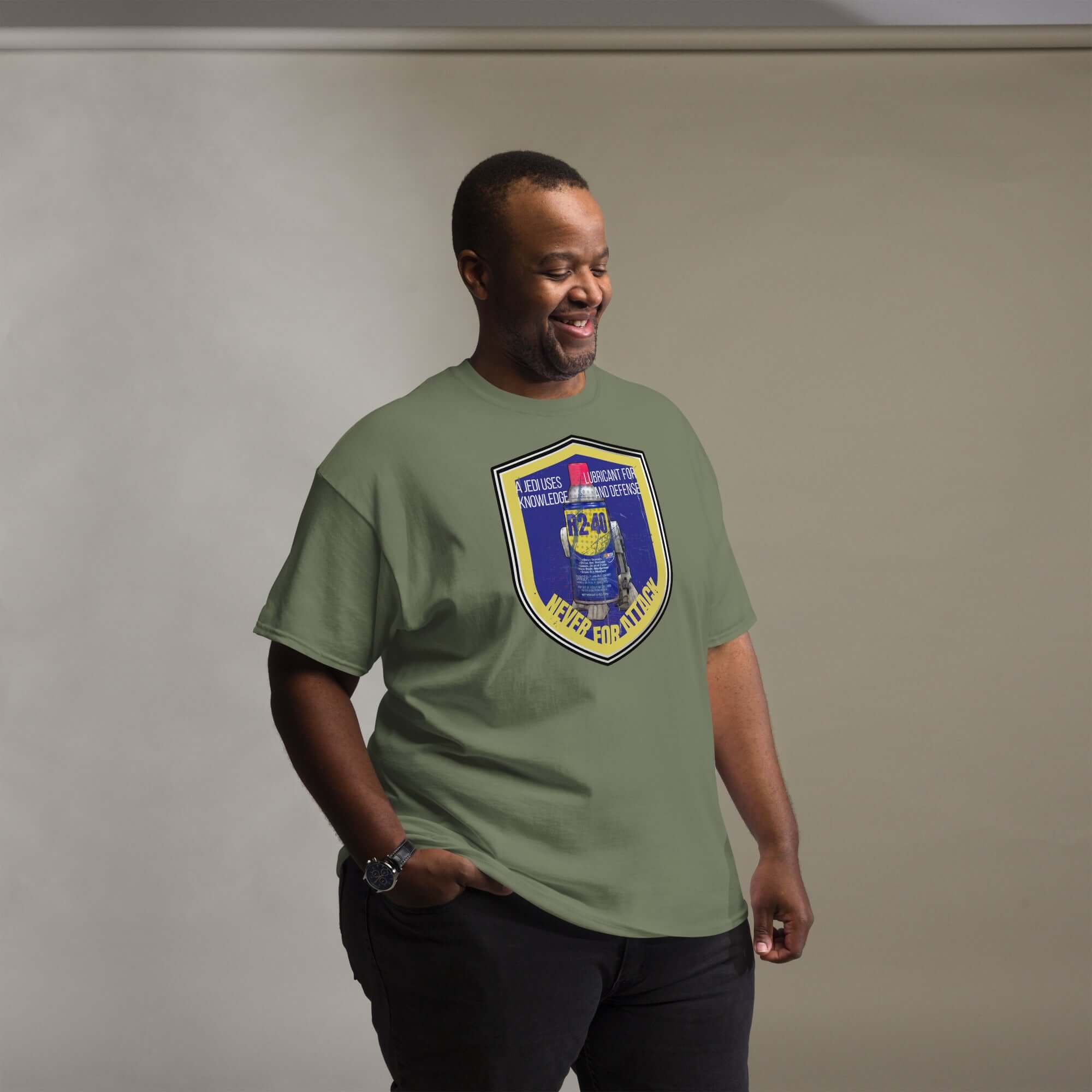 Man wearing R2-D2 WD-40 Parody T-Shirt with Star Wars mechanic humor design in green color.