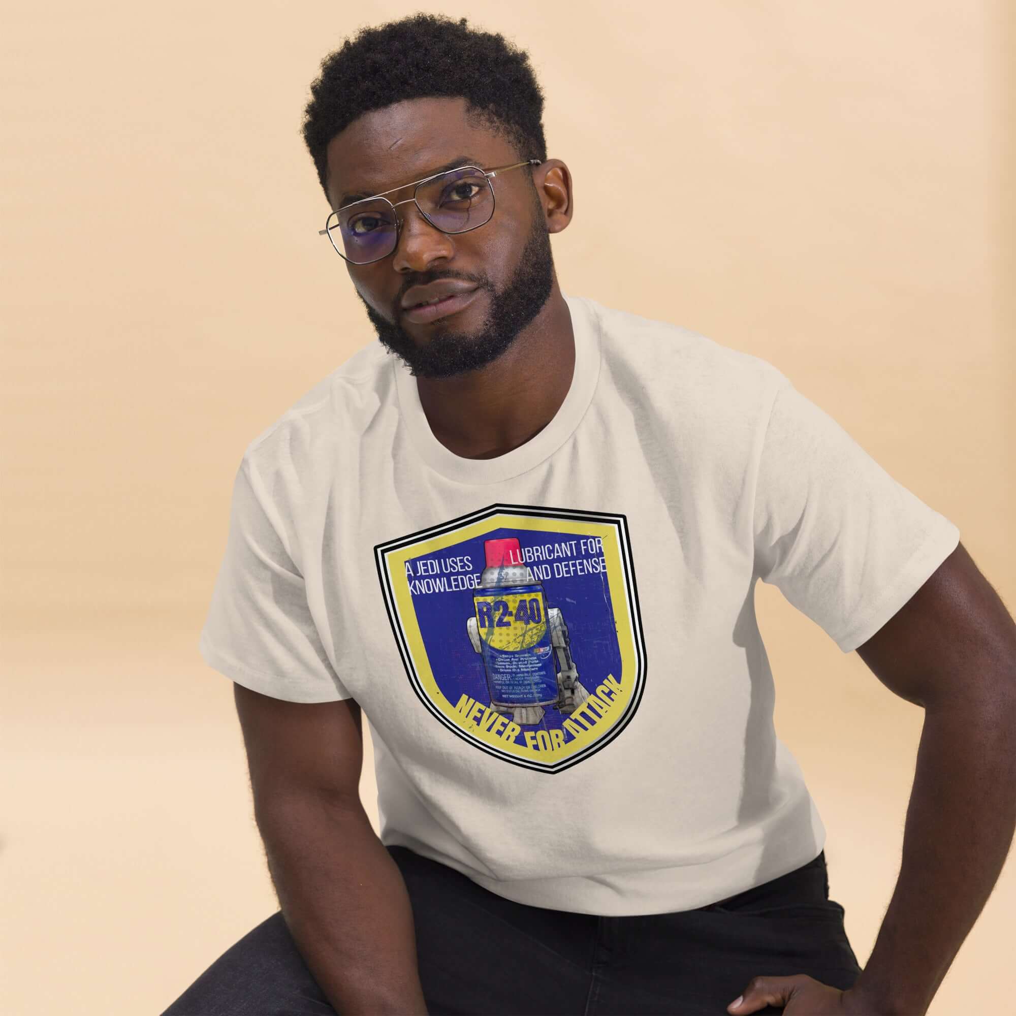 Man wearing R2-D2 WD-40 parody t-shirt with Star Wars mechanic humor design slogan "A Jedi Uses Lubricant For Knowledge and Defense".
