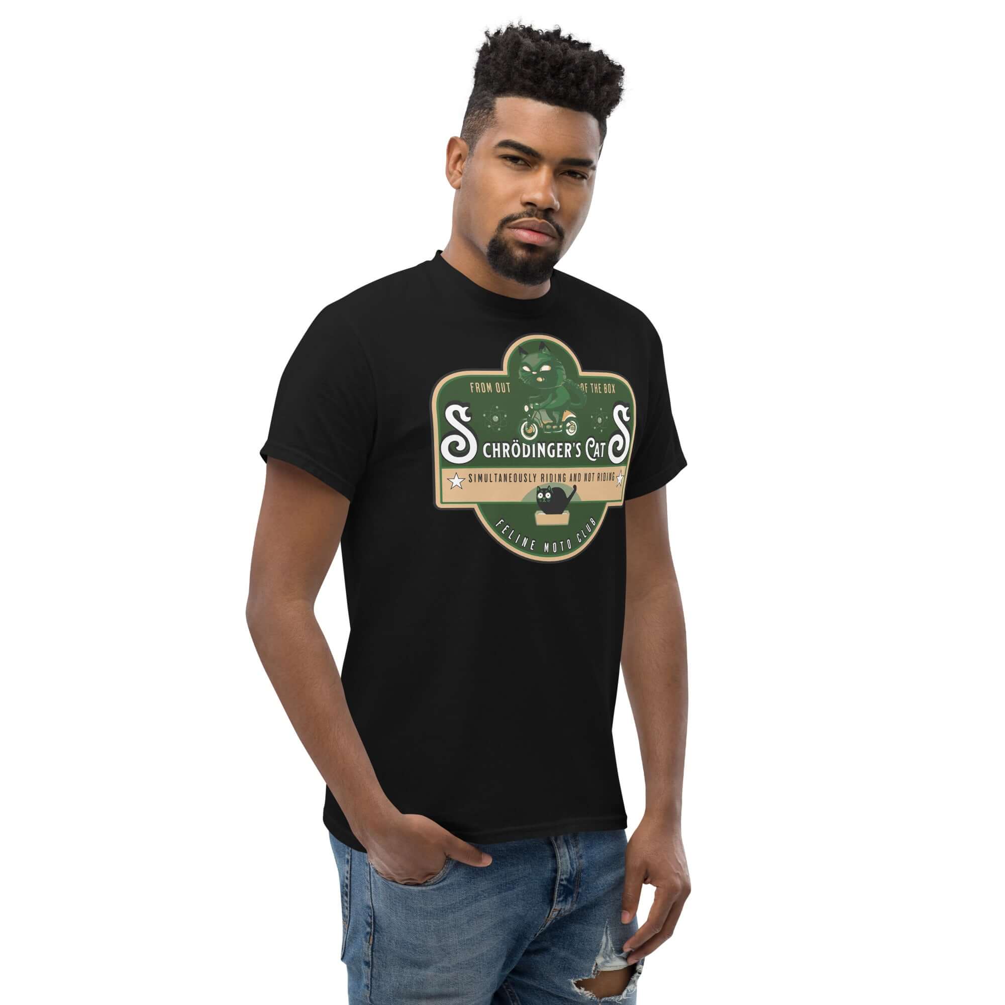 Model wearing Schrödinger's Cats Motorcycle Club T-Shirt featuring green cat logo, blending quantum physics with biker style.