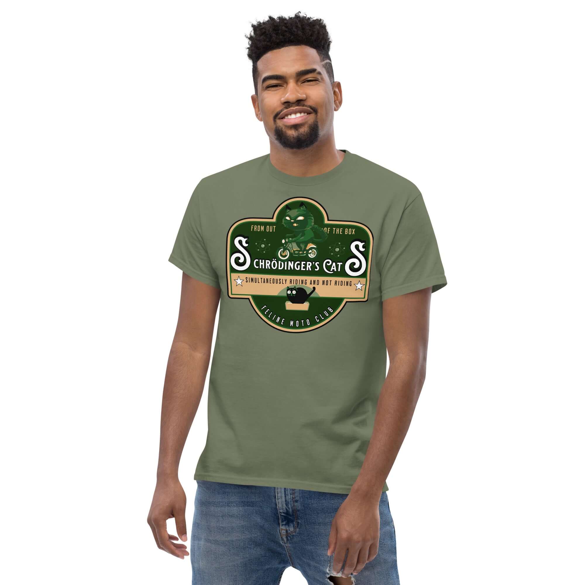 Man wearing Schrödinger's Cats Motorcycle Club T-Shirt with green cat emblem, embracing quantum physics and biker culture.
