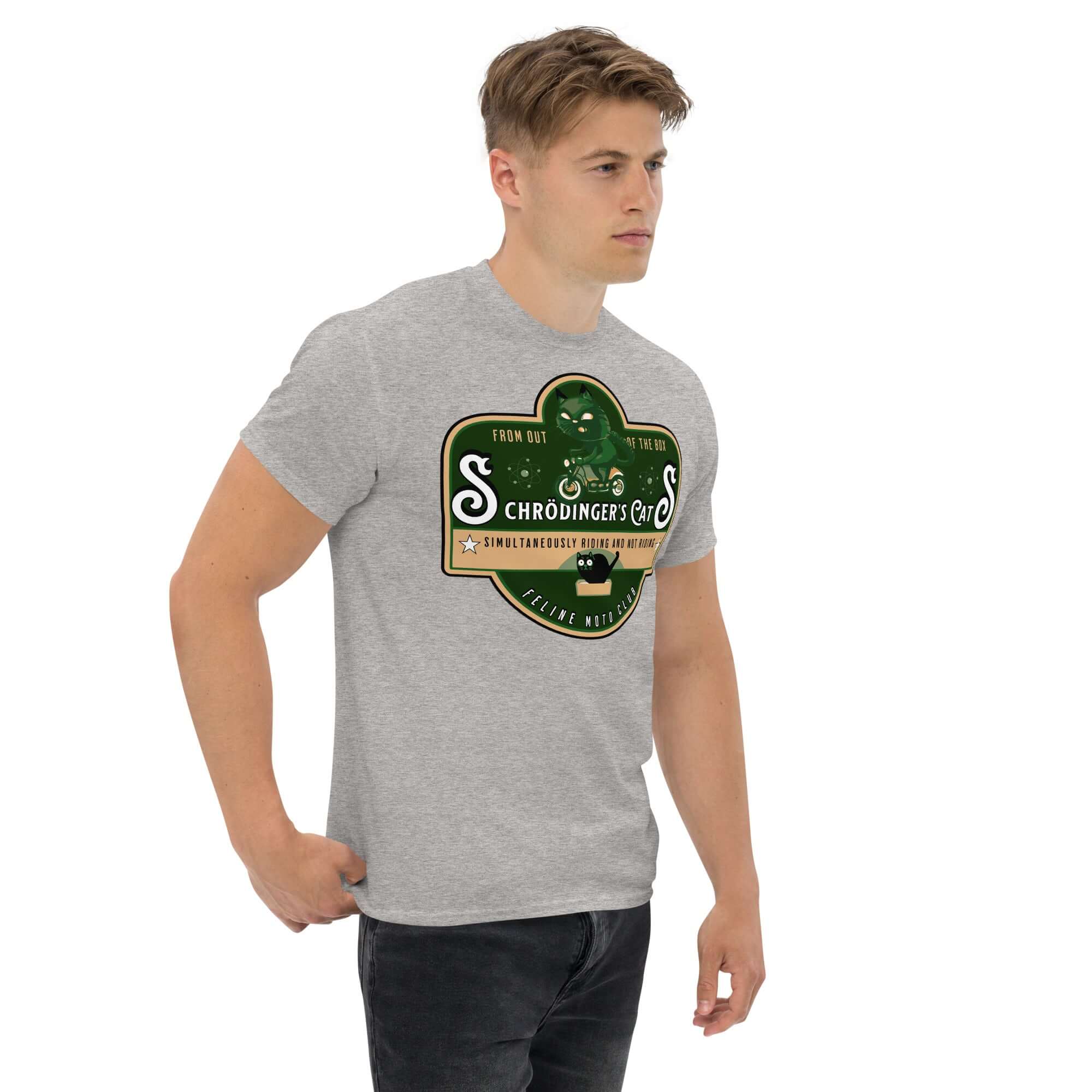 Model wearing Schrödinger's Cats Motorcycle Club T-Shirt with green feline biker logo, quantum physics theme.