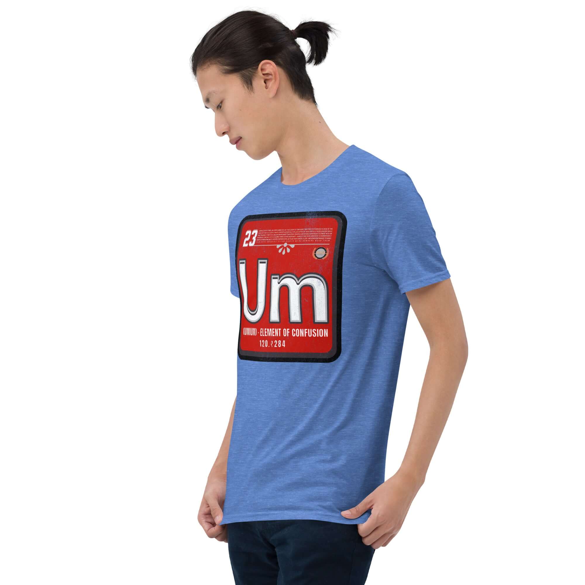 Man wearing Umium Element T-Shirt featuring Periodic Table of Confusion design on a blue fabric with red background print.