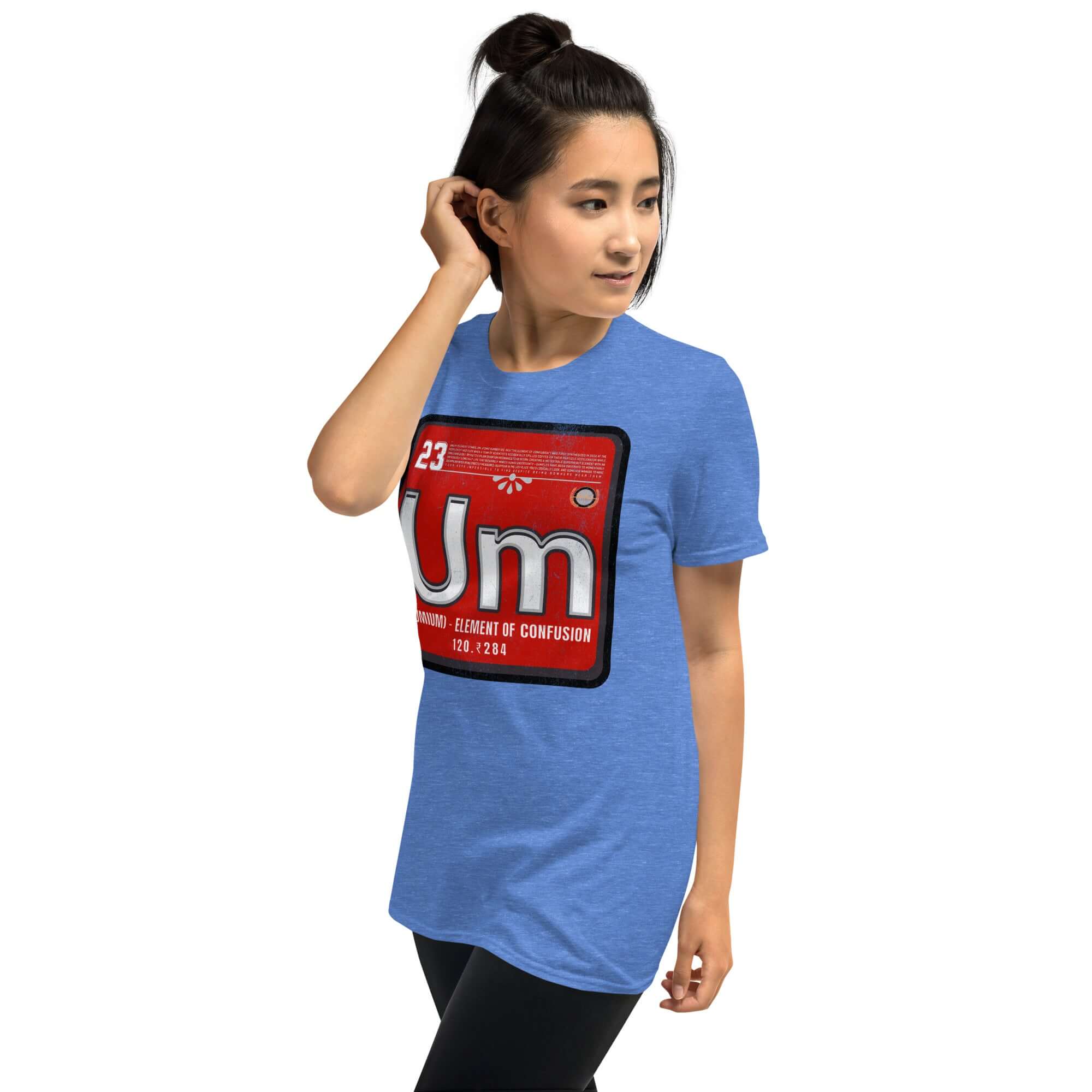 Woman wearing blue Umium Element T-Shirt featuring Periodic Table of Confusion on a vibrant red background.