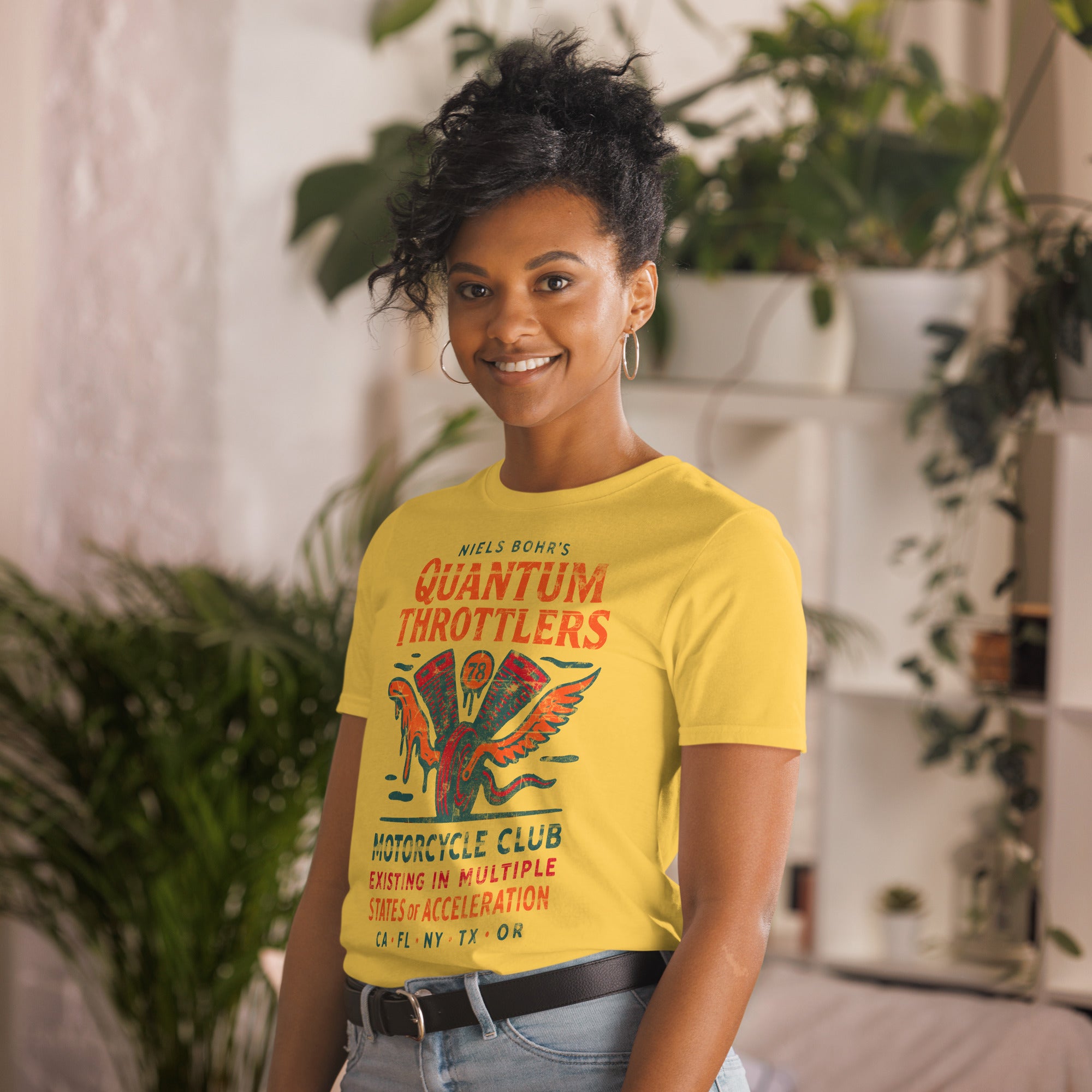 Woman wearing Niels Bohr Quantum Throttlers Motorcycle Club t-shirt with winged V-twin engine design.