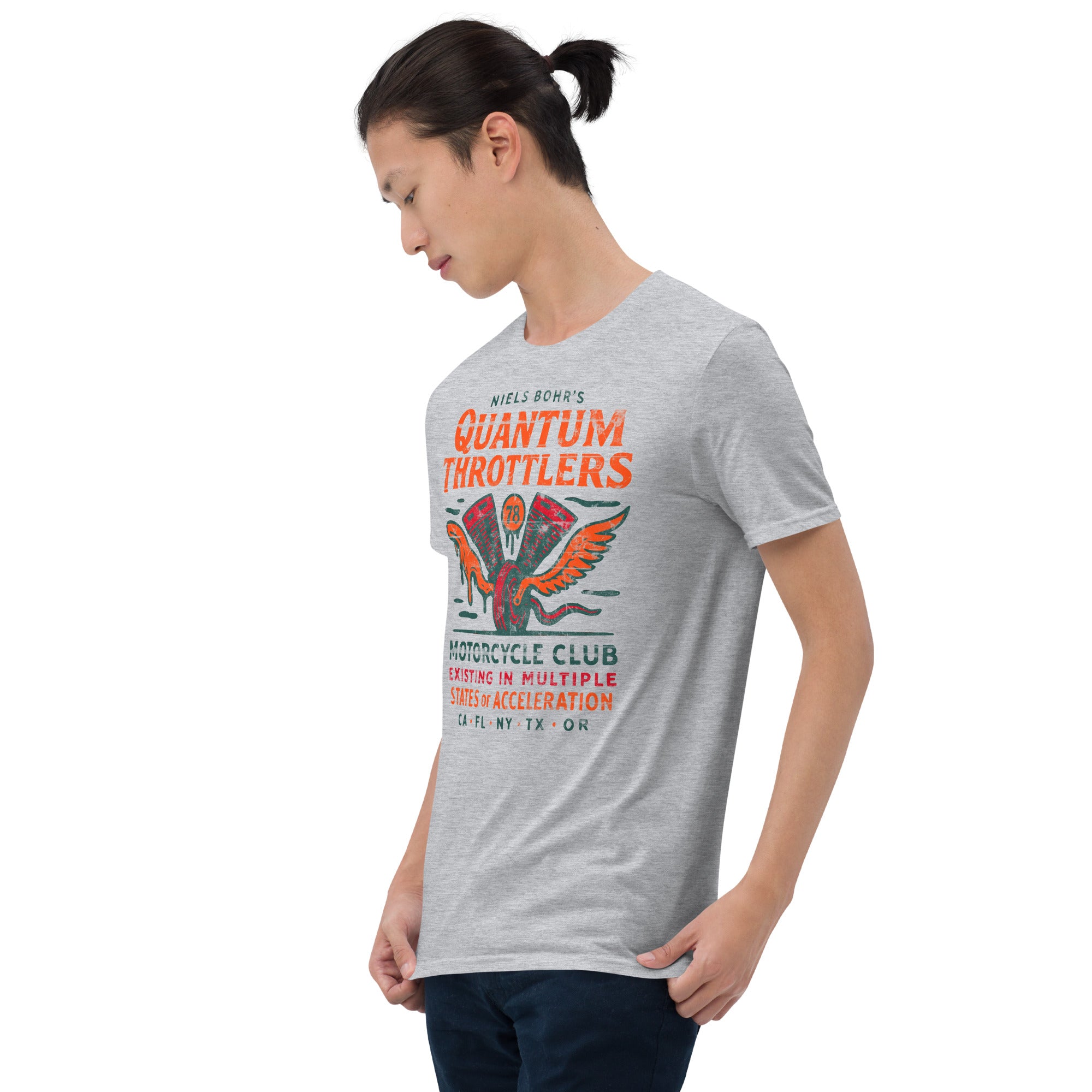 Person wearing Quantum Throttlers Motorcycle Club t-shirt featuring Niels Bohr physics design with winged V-twin engine graphic.