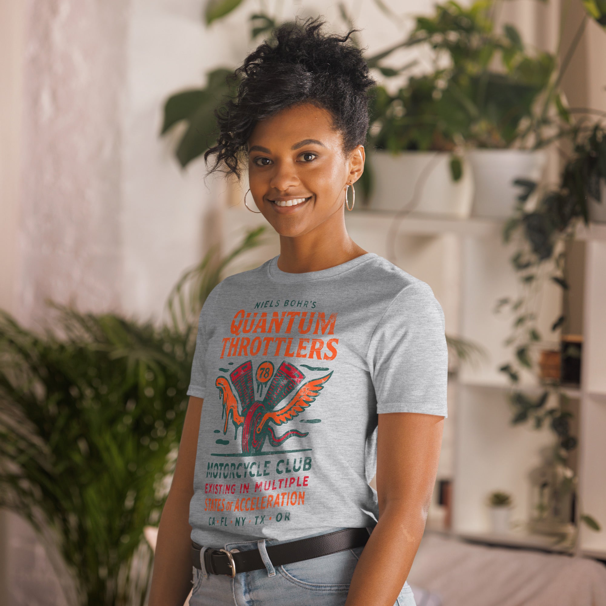 Niels Bohr Physics Biker T-Shirt with Quantum Throttlers design, featuring a woman modeling in a stylish indoor setting.